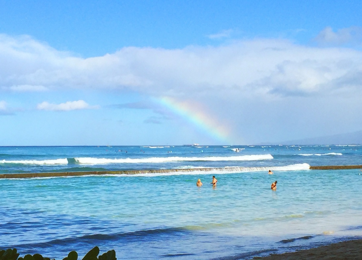 The iconic Waikiki Beach in Oahu with turquoise water and surfers