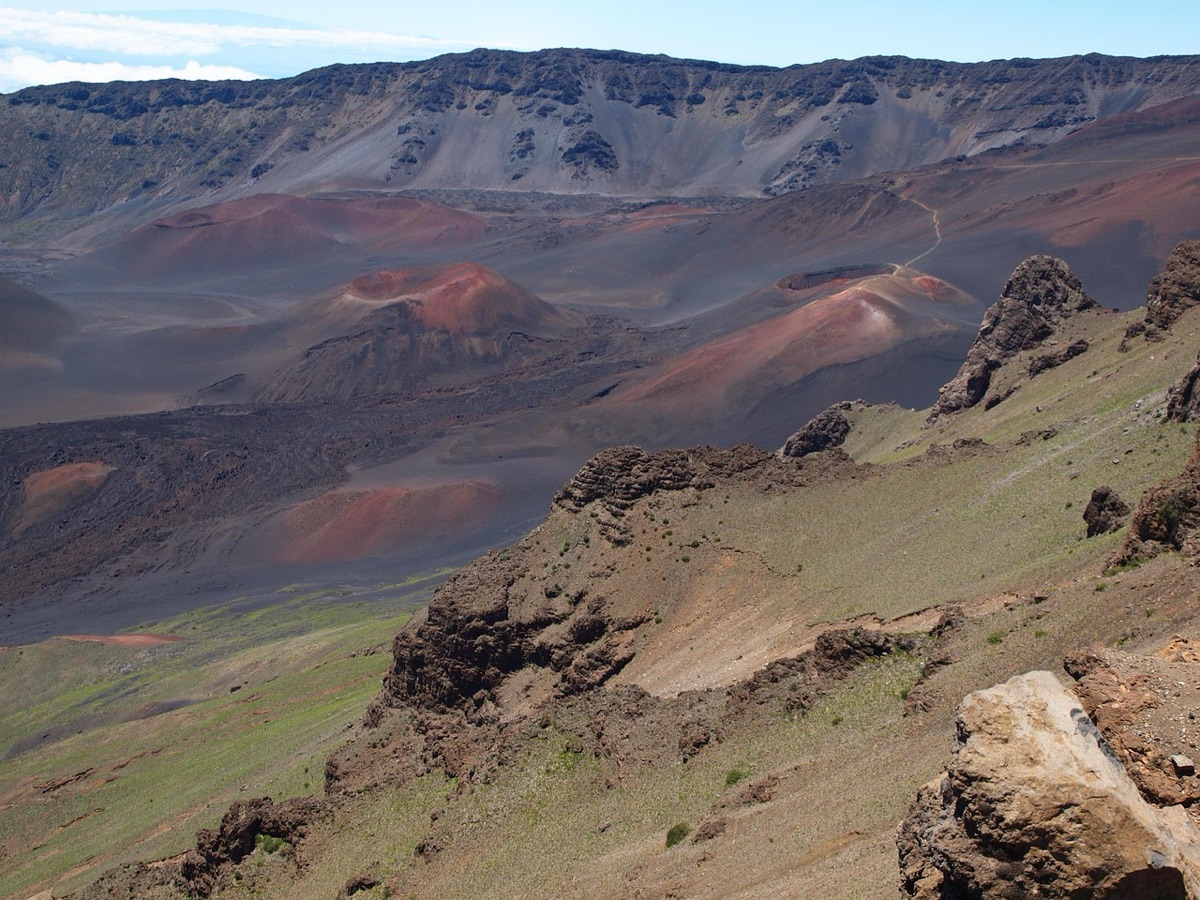 Local hawaii tour guide pointing at volcano
