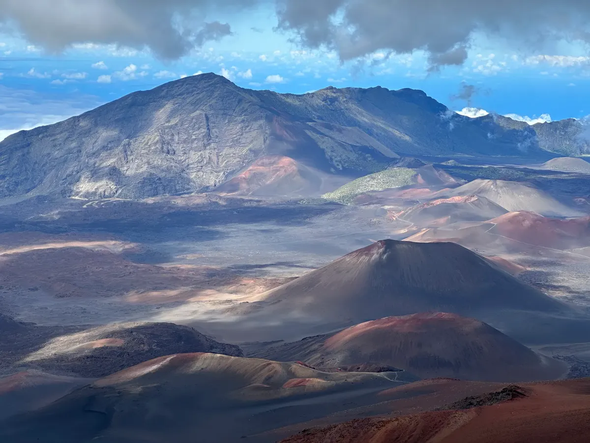 Breathtaking aerial view of Haleakalā volcanic landscape in Hawaii, showcasing rich geological features and vibrant colors.